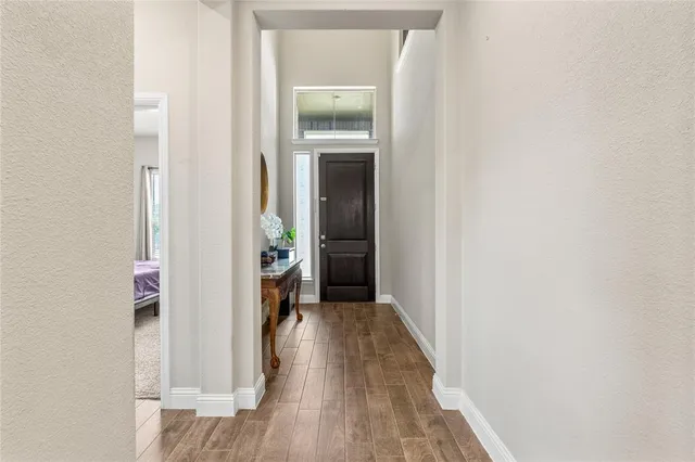 a view of a hallway with wooden floor