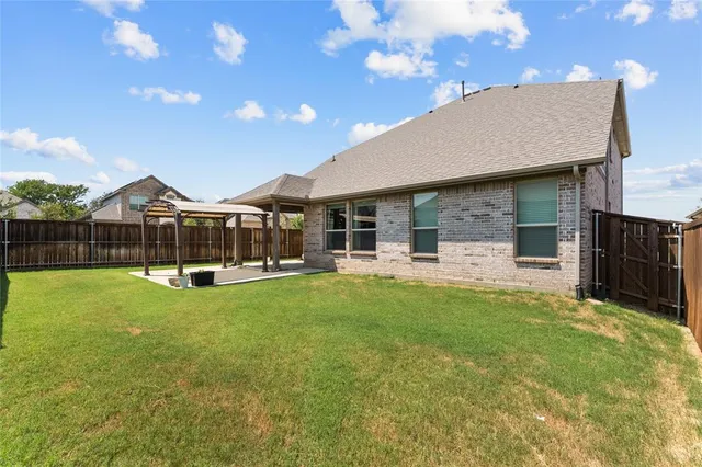 a swimming pool with outdoor seating and yard