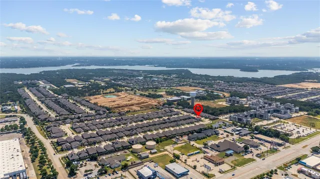 an aerial view of residential houses with city view
