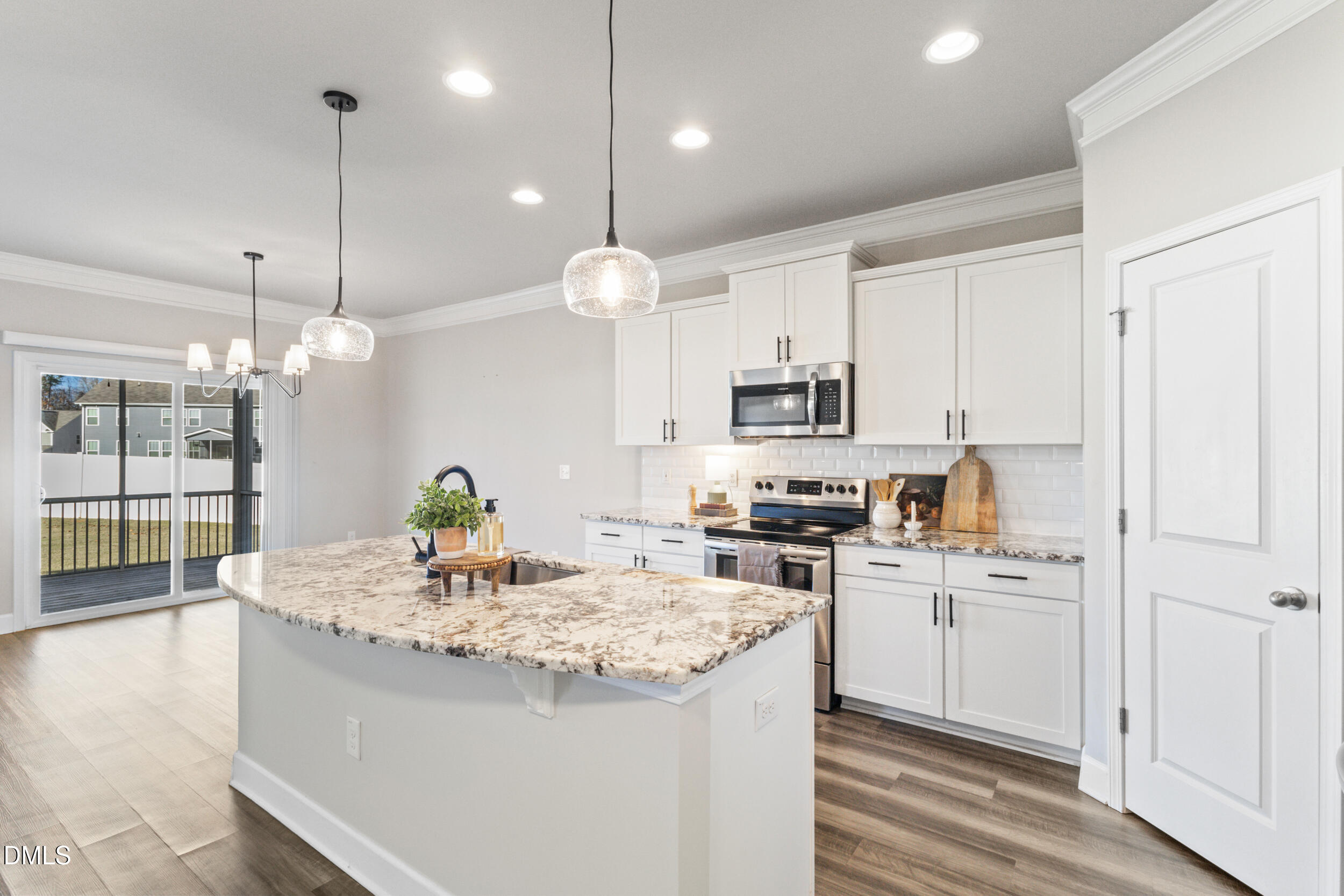 1024 JARRETT BAY Road Willow Spring, NC 27592 - Photo 14 of 43 a kitchen with kitchen island granite countertop a sink a stove and cabinets