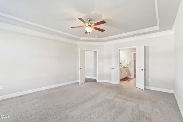a view of an empty room with wooden floor fireplace and a window
