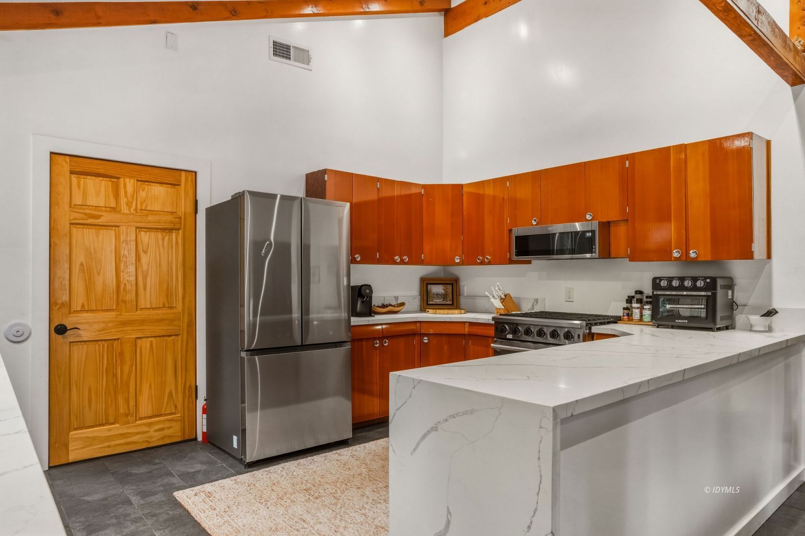 25106 Rim Rock Road Idyllwild, CA 92549 - Photo 17 of 71 a kitchen with stainless steel appliances a refrigerator a sink a stove a microwave and island