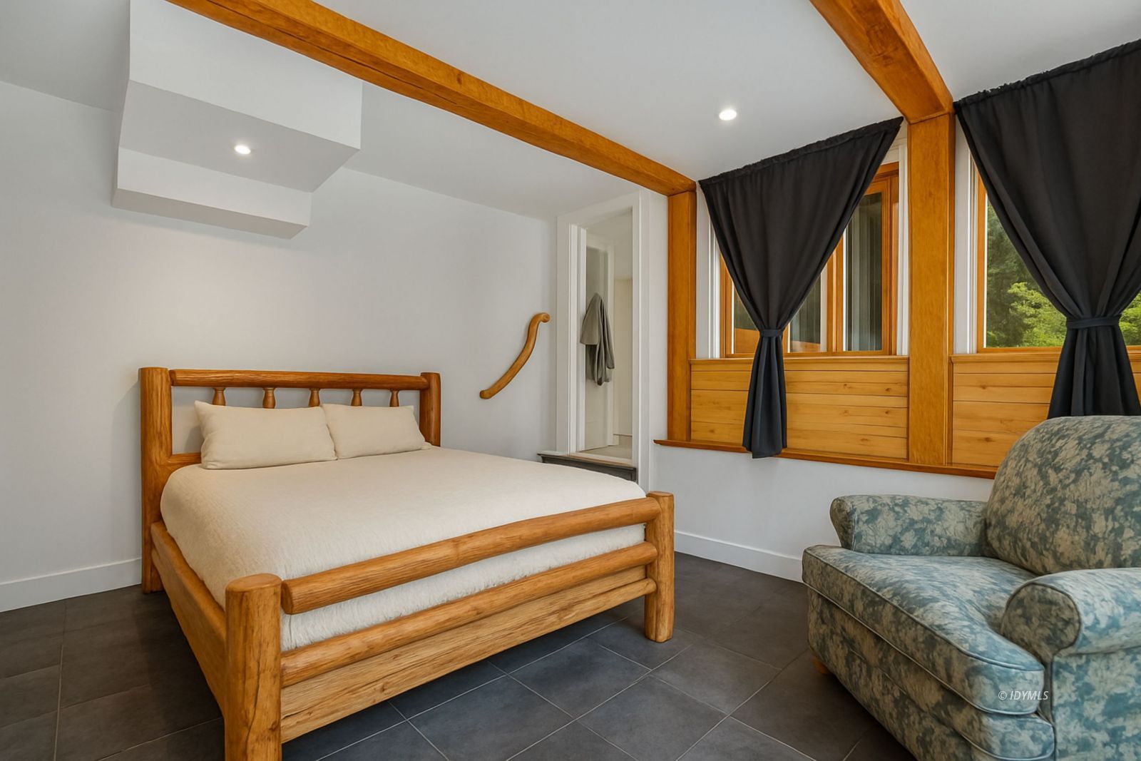 25106 Rim Rock Road Idyllwild, CA 92549 - Photo 55 of 71 a bedroom with a bed couch and a window