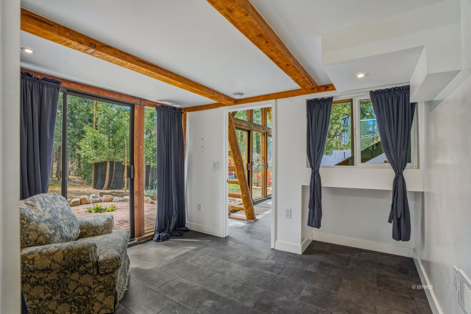 25106 Rim Rock Road Idyllwild, CA 92549 - Photo 56 of 71 a living room with furniture and a floor to ceiling window