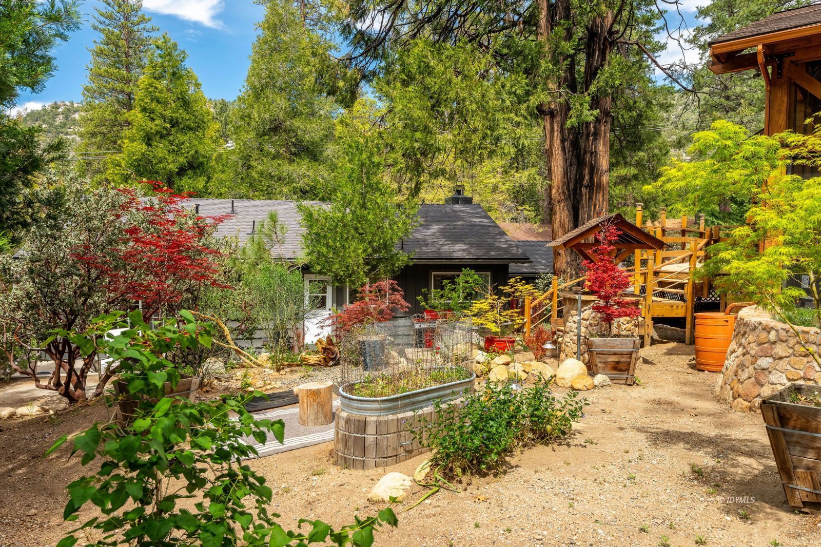 25106 Rim Rock Road Idyllwild, CA 92549 - Photo 61 of 71 a view of a patio with table and chairs and potted plants