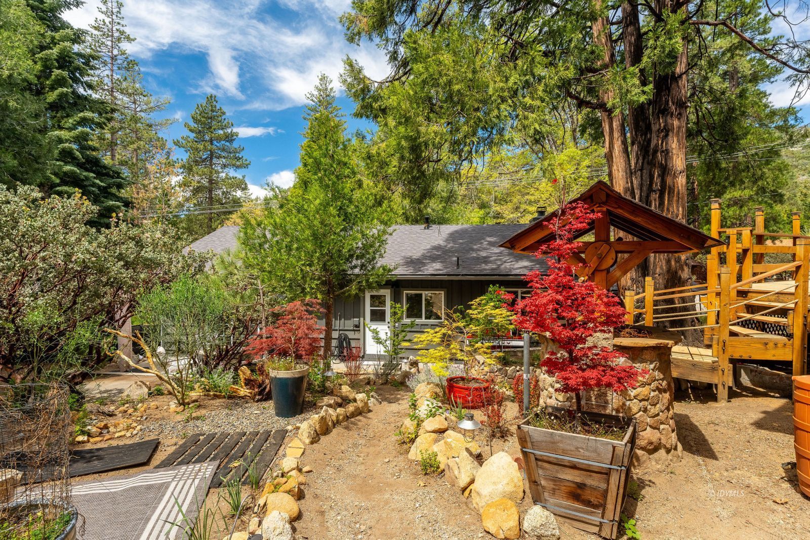 25106 Rim Rock Road Idyllwild, CA 92549 - Photo 67 of 71 a view of a patio with table and chairs and potted plants