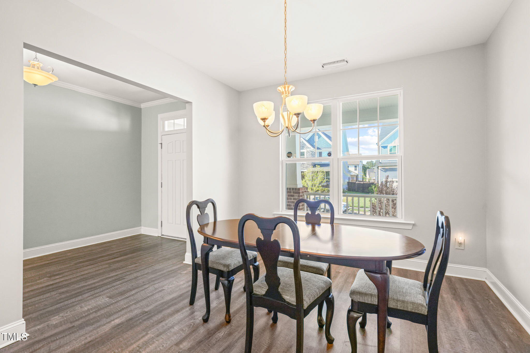 4508 Brintons Cottage Street Raleigh, NC 27616 - Photo 16 of 46 a view of a dining room with furniture a chandelier and wooden floor