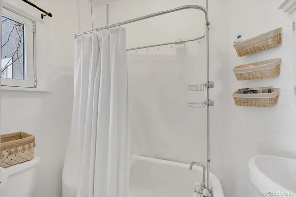 a bathroom with a shower curtain and a sink