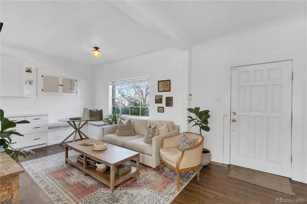 a living room with furniture rug and window