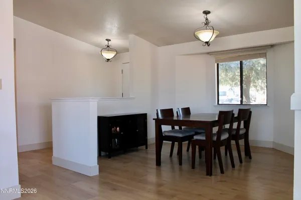 a view of a dining room with furniture and chandelier
