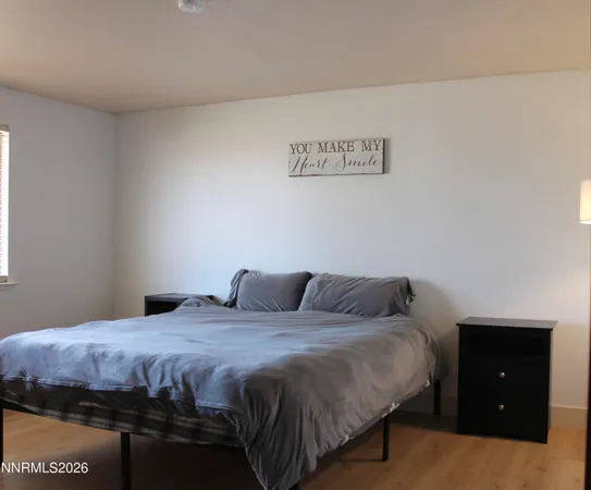 a bedroom with a bed and a night stand