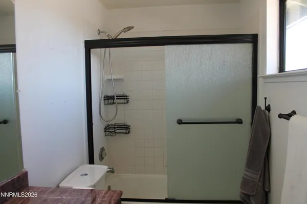 a bathroom with a shower and a sink