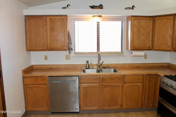 a view of a kitchen with sink and wooden floor