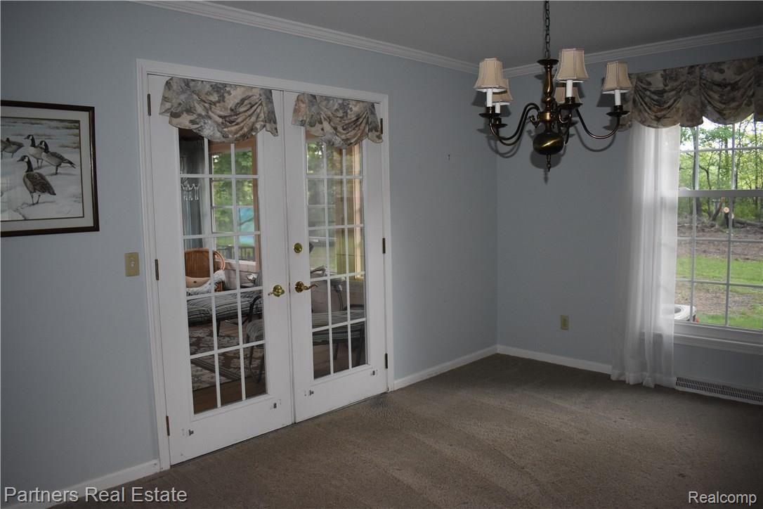 4400 Golf Club Road Howell, MI 48843 - Photo 19 of 68 Dining room with seasonal sunroom through French doors