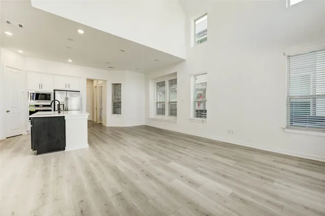 a kitchen with stainless steel appliances a refrigerator and a stove top oven