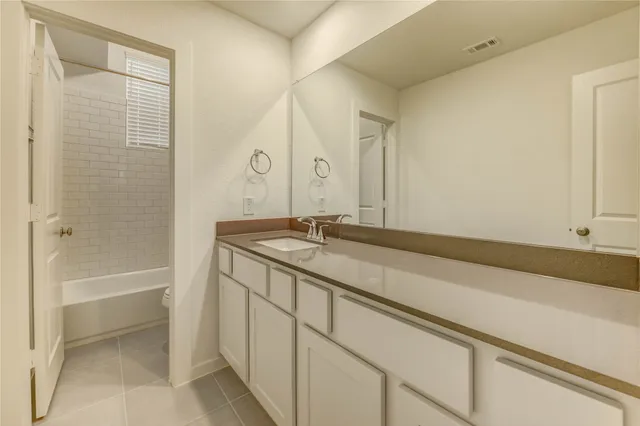 a bathroom with a bathtub and a sink