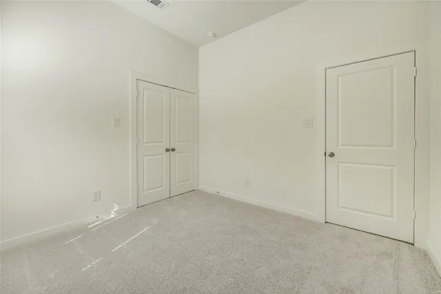 an empty room with closet area