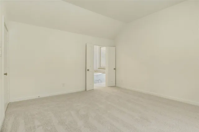 a view of an empty room and a window