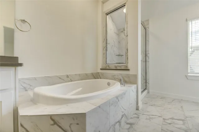 a bath tub sitting next to a white sink
