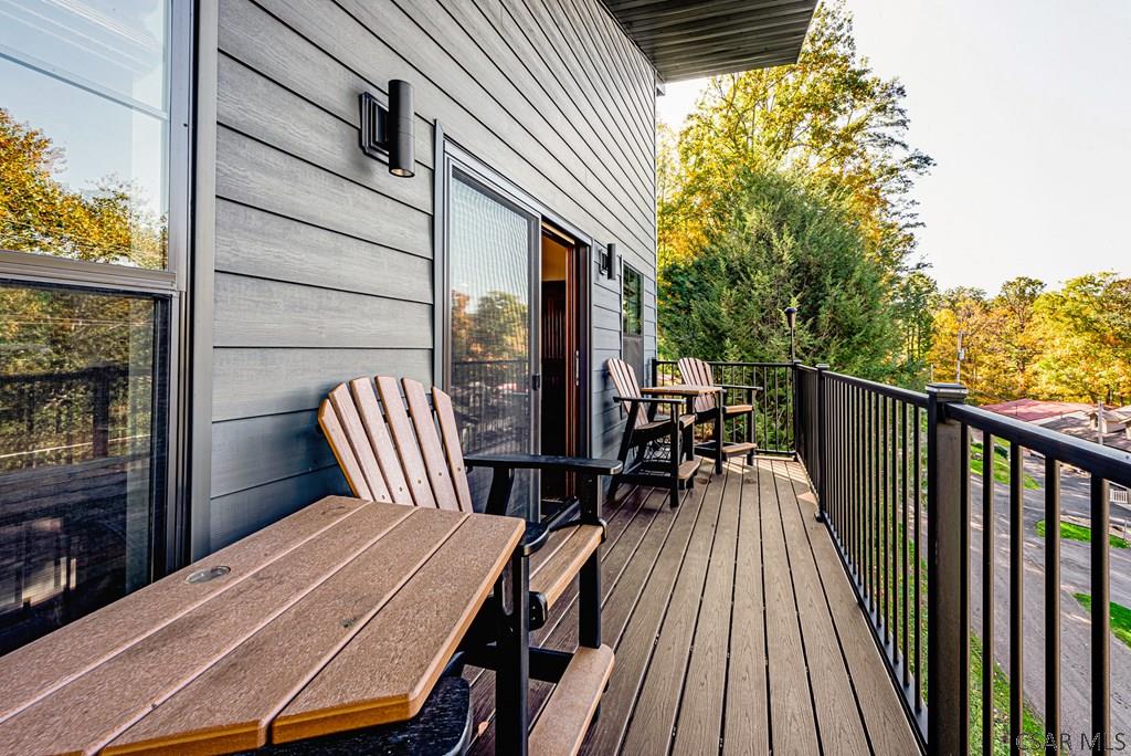 539 Lake Side Road Addison, PA 15411 - Photo 18 of 42 a view of a patio with table and chairs next to a large window with wooden floor