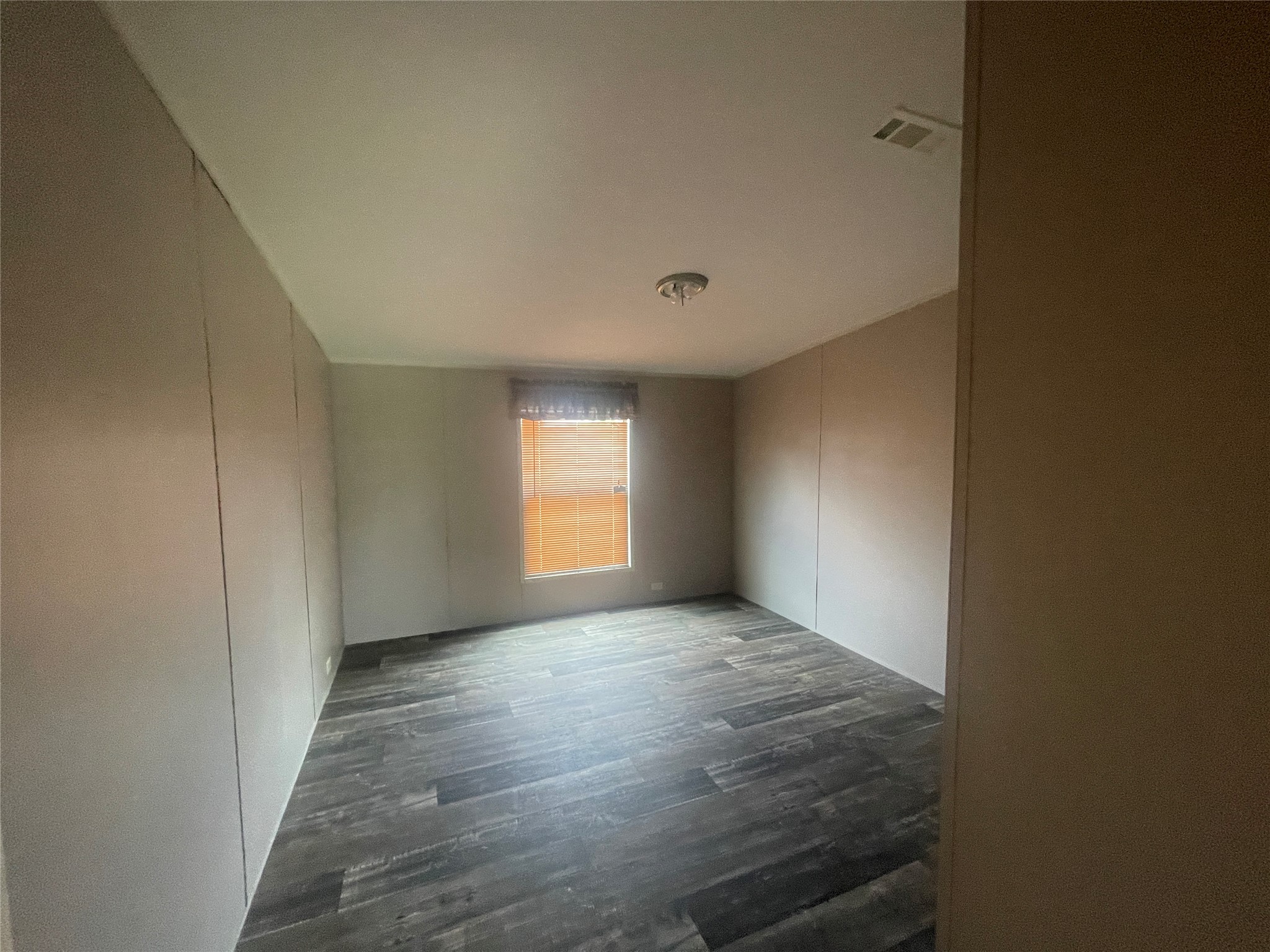 7855 Taylorsville Road Dale, TX 78616 - Photo 10 of 12 An inviting room boasts dark wood-look flooring and a sun-filled window.