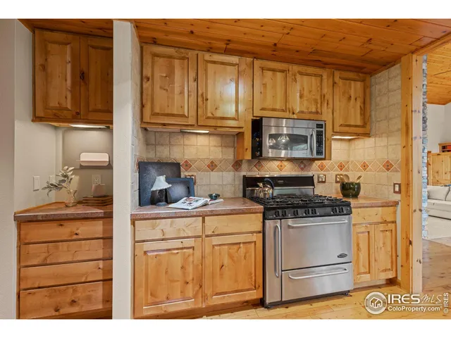 a kitchen with stainless steel appliances granite countertop a stove and a microwave