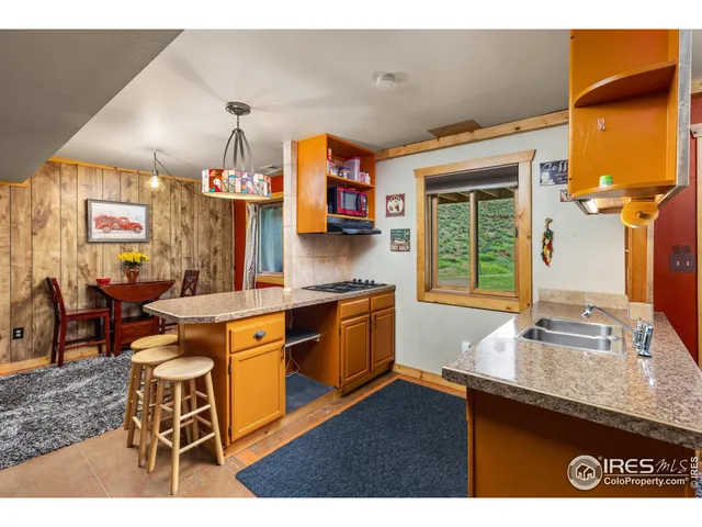 a kitchen with stainless steel appliances granite countertop a sink and a refrigerator