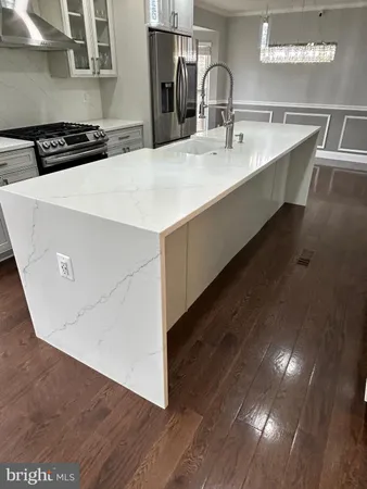 a kitchen with kitchen island sink and stove