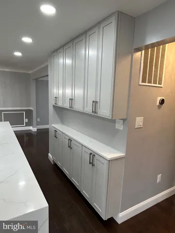 a kitchen with a sink and wooden floor