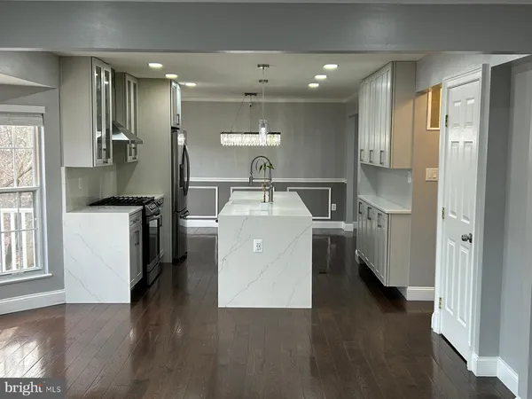 a bathroom with a sink a mirror and shower
