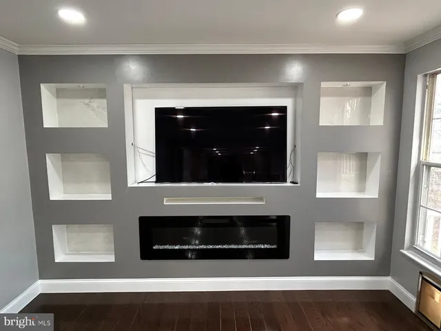 a living room with a fireplace and a potted plant