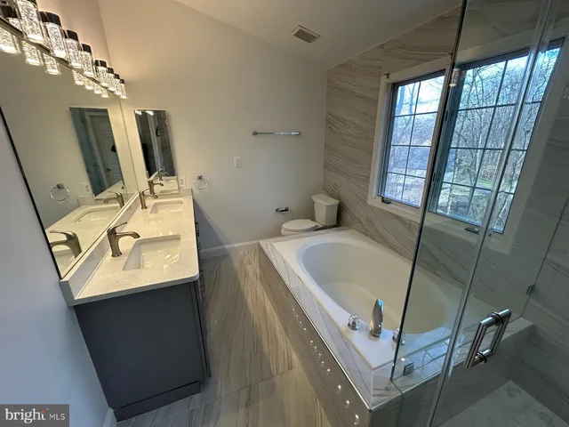 a bathroom with a sink a mirror and a bathtub