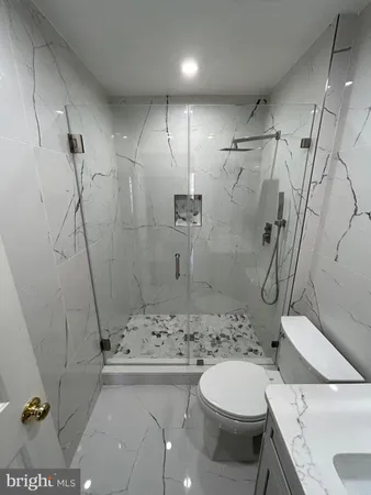 a bathroom with a shower toilet and sink