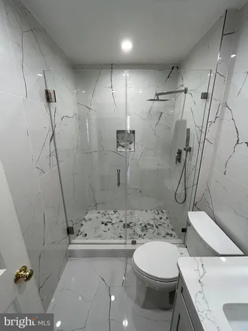 a bathroom with a shower toilet and sink
