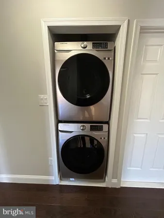 a bathroom with a granite countertop toilet and a sink