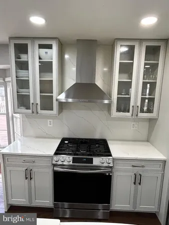 a kitchen with stainless steel appliances granite countertop a stove and a sink