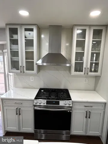 a kitchen with stainless steel appliances granite countertop a stove and a sink