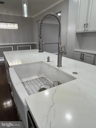 a bathroom with a granite countertop sink