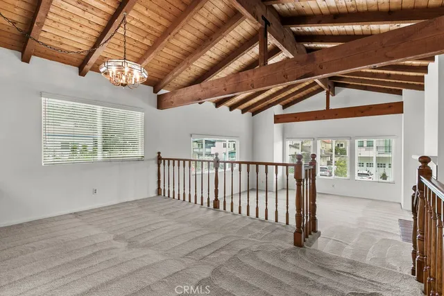 a view of a room with wooden walls and windows