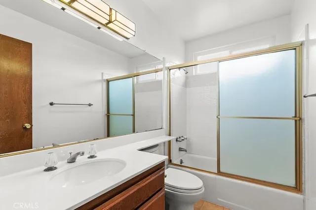 a bathroom with a sink a mirror and a toilet