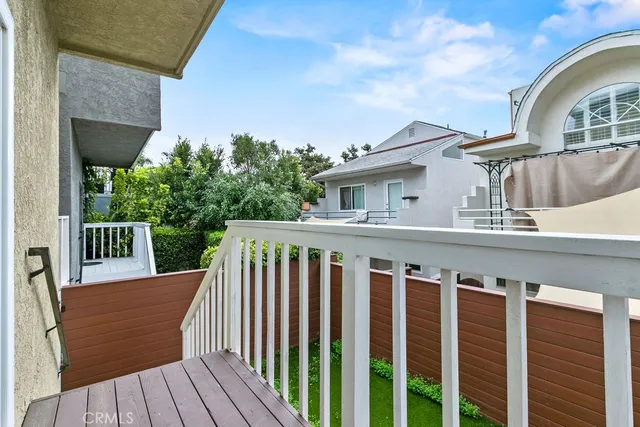 a view of a balcony with wooden floor and fence
