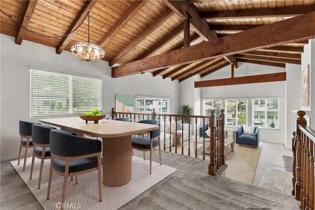 a dining room with furniture a rug and wooden floor