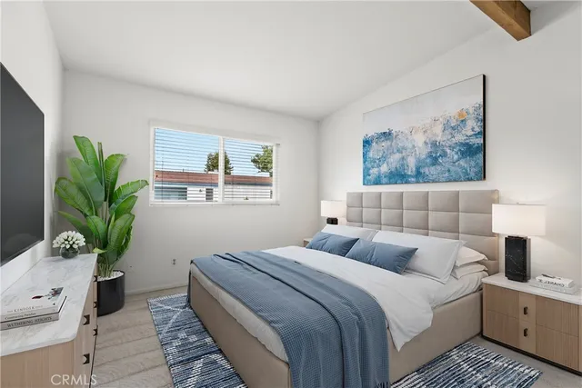 a bedroom with a large bed and a potted plant