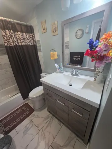 a bathroom with a sink mirror vanity and toilet