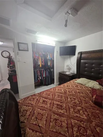 a bedroom with a bed and a walk in closet