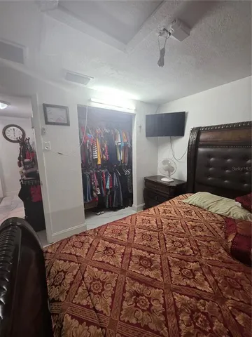 a bedroom with a bed and a walk in closet