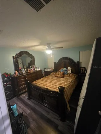 a bedroom with a bed and dresser with mirror