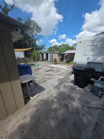 a view of a patio with table and chairs with wooden fence and plants
