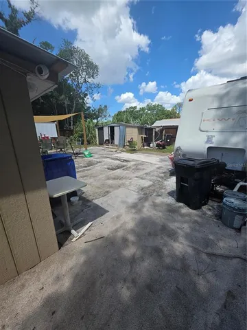a view of a patio with table and chairs with wooden fence and plants