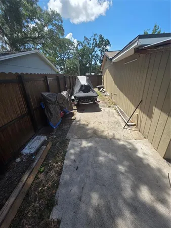 a view of backyard with outdoor seating and trees